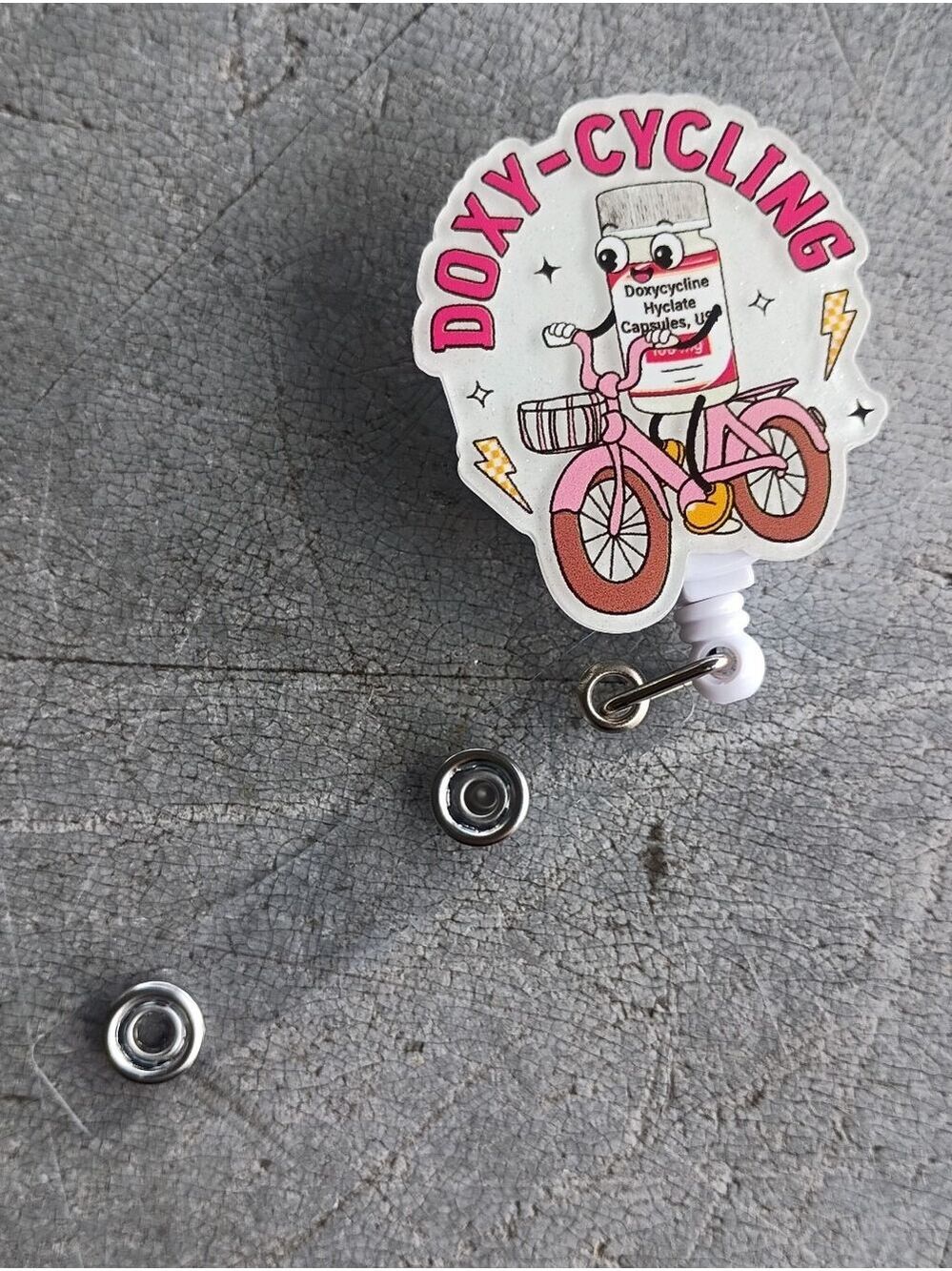 Doxy-Cycling Pink Bottle Badge Reel
